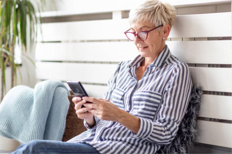 Woman sitting with her mobile phone